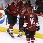 Arizona Coyotes left wing Brendan Perlini (11) celebrates his goal against the Vegas Golden Knights with center Derek Stepan (21) and left wing Max Domi (16) during the third period of an NHL hockey game Saturday, Nov. 25, 2017, in Glendale, Ariz. The Golden Knights defeated the Coyotes 4-2. (AP Photo/Ross D. Franklin)