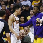 Referee Marat Kogut (32) rushes in to get between Phoenix Suns guard Devin Booker, second from left, and Los Angeles Lakers' Kentavious Caldwell-Pope, second from right, and Julius Randle, right, as the players exchange words during the second half of an NBA basketball game Monday, Nov. 13, 2017, in Phoenix. The Lakers defeated the Suns 100-93. (AP Photo/Ross D. Franklin)