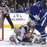 Arizona Coyotes goalie Antti Raanta (32) makes a save against Toronto Maple Leafs center Zach Hyman (11) during first-period NHL hockey game action in Toronto, Monday, Nov. 20, 2017. (Nathan Denette/The Canadian Press via AP)