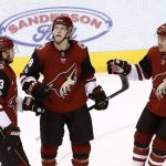 Arizona Coyotes center Christian Dvorak, middle, celebrates his goal against the Buffalo Sabres with defenseman Oliver Ekman-Larsson (23) and left wing Max Domi (16) during the third period of an NHL hockey game Thursday, Nov. 2, 2017, in Glendale, Ariz. The Sabres won 5-4. (AP Photo/Ross D. Franklin)