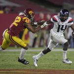 Arizona quarterback Khalil Tate, right, tries to escape a tackle by Southern California linebacker Uchenna Nwosu during the first half of an NCAA college football game, Saturday, Nov. 4, 2017, in Los Angeles. (AP Photo/Mark J. Terrill)