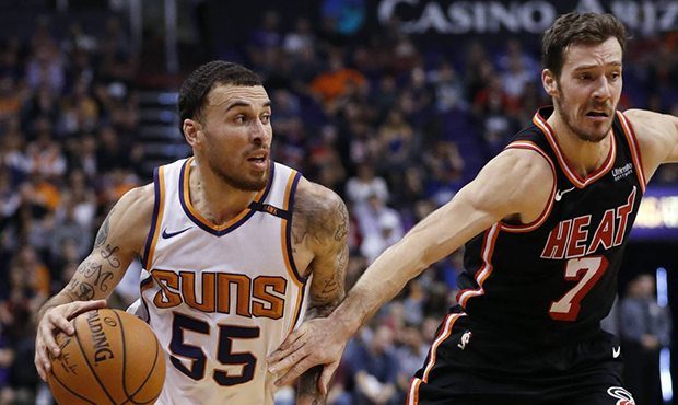 Phoenix Suns guard Mike James (55) slips past Miami Heat guard Goran Dragic (7) during the second h...