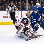 Arizona Coyotes goalie Antti Raanta, left, makes a save against Toronto Maple Leafs center Zach Hyman, right,  during first period NHL hockey action in Toronto on  Monday, Nov. 20, 2017. (Nathan Denette/The Canadian Press via AP)