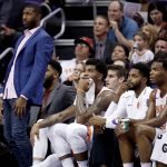 Newly acquired Phoenix Suns' injured center Greg Monroe, left, watches from the bench during the first half of an NBA basketball game against the Orlando Magic, Friday, Nov. 10, 2017, in Phoenix. (AP Photo/Matt York)