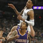 San Antonio Spurs' Dejounte Murray (5) tries to go over Phoenix Suns' Tyler Ulis(8) during an NBA basketball game on Sunday, Nov. 5, 2017 in San Antonio. (AP Photo/Ronald Cortes)
