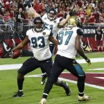 Jacksonville Jaguars defensive end Calais Campbell (93) celebrates his fumble recovery for a touchdown with defensive tackle Malik Jackson (97) and middle linebacker Paul Posluszny (51) during the second half of an NFL football game against the Arizona Cardinals, Sunday, Nov. 26, 2017, in Glendale, Ariz. (AP Photo/Ross D. Franklin)