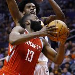Houston Rockets guard James Harden (13) slips past Phoenix Suns forward Josh Jackson, back, to get off a shot during the first half of an NBA basketball game Thursday, Nov. 16, 2017, in Phoenix. (AP Photo/Ross D. Franklin)