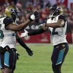 Jacksonville Jaguars strong safety Barry Church (42) celebrates his interception against the Arizona Cardinals with defensive end Dante Fowler (56) during the second half of an NFL football game, Sunday, Nov. 26, 2017, in Glendale, Ariz. (AP Photo/Rick Scuteri)