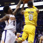 Phoenix Suns forward Marquese Chriss, left, blocks the shot of Los Angeles Lakers forward Kyle Kuzma, right, during the first half of an NBA basketball game Monday, Nov. 13, 2017, in Phoenix. (AP Photo/Ross D. Franklin)