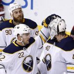 Buffalo Sabres goalie Robin Lehner (40) celebrates the team's 5-4 win over the Arizona Coyotes with Johan Larsson (22) and Ryan O'Reilly (90) at the end of an NHL hockey game Thursday, Nov. 2, 2017, in Glendale, Ariz. (AP Photo/Ross D. Franklin)