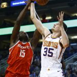 Phoenix Suns forward Dragan Bender (35) and Houston Rockets center Clint Capela (15) go up for a rebound during the second half of an NBA basketball game Thursday, Nov. 16, 2017, in Phoenix. The Rockets defeated the Suns 142-116. (AP Photo/Ross D. Franklin)