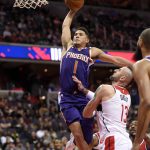 Phoenix Suns guard Devin Booker (1) goes to the basket against Washington Wizards center Marcin Gortat (13), of Poland, during the second half of an NBA basketball game, Wednesday, Nov. 1, 2017, in Washington. The Suns won 122-116. (AP Photo/Nick Wass)