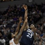 Minnesota Timberwolves guard Jimmy Butler (23) shoots against Phoenix Suns guard Troy Daniels (30) during the third quarter of an NBA basketball game on Sunday, Nov. 26, 2017, in Minneapolis. (AP Photo/Hannah Foslien)