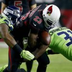 Arizona Cardinals running back Adrian Peterson (23) fumbles the football as Seattle Seahawks strong safety Kam Chancellor (31) and defensive tackle Sheldon Richardson make the hit prior to an NFL football game, Thursday, Nov. 9, 2017, in Glendale, Ariz. The Seahawks recovered the ball. (AP Photo/Ross D. Franklin)