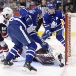 Toronto Maple Leafs left wing James van Riemsdyk (25) scores against Arizona Coyotes goalie Antti Raanta (obscured) as centre Tyler Bozak (42) and Coyotes defenseman Jason Demers (55) look on during second period NHL hockey action in Toronto on Monday, Nov. 20, 2017. (Nathan Denette/The Canadian Press via AP)