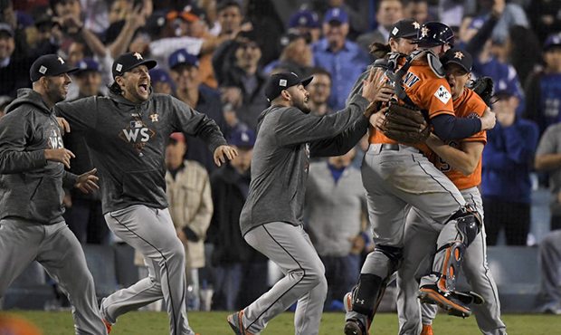 Members the the Houston Astros celebrate their win against the Los Angeles Dodgers in Game 7 of bas...