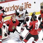 Ottawa Senators goaltender Mike Condon (1), Erik Karlsson (65), Ryan Dzingel (18), Ben Harpur (67) and Arizona Coyotes' Christian Fischer (36) watch the puck as it bounces in the air during the second period of an NHL hockey game in Ottawa, Saturday, Nov. 18, 2017. (Justin Tang/The Canadian Press via AP)