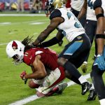 Arizona Cardinals wide receiver Larry Fitzgerald (11) scores a two point conversion as Jacksonville Jaguars free safety Tashaun Gipson defends during the second half of an NFL football game, Sunday, Nov. 26, 2017, in Glendale, Ariz. (AP Photo/Ross D. Franklin)