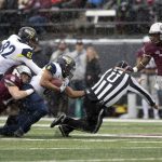 Northern Arizona running back Cory Young (6) collides with field umpire Roger Stewart as he is tackled by Montana safety Josh Sandry (13) in the first half of an NCAA college football game Saturday, Nov. 4, 2017, in Missoula, Mont. (AP Photo/Patrick Record)