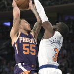 New York Knicks forward Tim Hardaway Jr., right, attempts to block a shot by Phoenix Suns guard Mike James (55) during the third quarter of an NBA basketball game Friday, Nov. 3, 2017, at Madison Square Garden in New York. (AP Photo/Bill Kostroun)