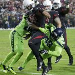 Arizona Cardinals tight end Jermaine Gresham (84) scores a touchdown as Seattle Seahawks defensive tackle Garrison Smith (98) and cornerback Justin Coleman defend during the first half of an NFL football game, Thursday, Nov. 9, 2017, in Glendale, Ariz. (AP Photo/Rick Scuteri)