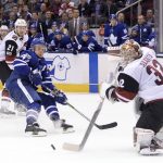 Arizona Coyotes goalie Antti Raanta (32) comes out of his crease to play the puck as center Derek Stepan (21) and Toronto Maple Leafs centre Leo Komarov (47) look on during second-period NHL hockey game action in Toronto, Monday, Nov. 20, 2017. (Nathan Denette/The Canadian Press via AP)