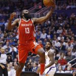 Houston Rockets guard James Harden (13) beats the Phoenix Suns defense, including guard Troy Daniels, right, to score during the first half of an NBA basketball game Thursday, Nov. 16, 2017, in Phoenix. (AP Photo/Ross D. Franklin)