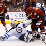 Winnipeg Jets goalie Steve Mason, front left, makes a sliding save on a shot by Arizona Coyotes center Christian Dvorak (18) as Coyotes' Brendan Perlini (11) and Jets' Josh Morrissey (44) look on during the second period of an NHL hockey game Saturday, Nov. 11, 2017, in Glendale, Ariz. The Jets defeated the Coyotes 4-1. (AP Photo/Ross D. Franklin)