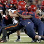 Arizona's defense swallows up Oregon State running back Ryan Nall (34) behind the line of scrimmage during the second quarter of an NCAA college football game Saturday, Nov. 11, 2017, Tucson, Ariz. (Kelly Presnell/Arizona Daily Star via AP)