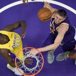 Phoenix Suns center Alex Len, right, of Ukraine, shoots as Los Angeles Lakers forward Julius Randle defends during the first half of an NBA basketball game, Friday, Nov. 17, 2017, in Los Angeles. (AP Photo/Mark J. Terrill)