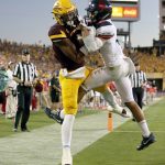 Arizona State wide receiver N'Keal Harry, left, catches a pass for a touchdown against Arizona cornerback Lorenzo Burns during the second half of an NCAA college football game, Saturday, Nov 25, 2017, in Tempe, Ariz. Arizona State defeated Arizona 42-30. (AP Photo/Rick Scuteri)