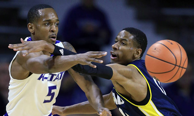 Kansas State guard Barry Brown (5) passes to a teammate while covered by Northern Arizona guard Tor...