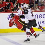 Arizona Coyotes' Christian Fischer hits Calgary Flames' Mark Giordano dduring the second period of an NHL hockey game Thursday, Nov. 30, 2017, in Calgary, Alberta. (Lyle Aspinall/The Canadian Press via AP)