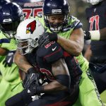 Arizona Cardinals running back Adrian Peterson (23) is stopped by Seattle Seahawks defensive end Michael Bennett during the first half of an NFL football game, Thursday, Nov. 9, 2017, in Glendale, Ariz. (AP Photo/Ross D. Franklin)