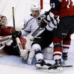 Los Angeles Kings left wing Tanner Pearson (70) gets shoved into Arizona Coyotes goalie Scott Wedgewood, left, during the third period of an NHL hockey game Friday, Nov. 24, 2017, in Glendale, Ariz. The Coyotes defeated the Kings 3-2 in overtime. (AP Photo/Ross D. Franklin)