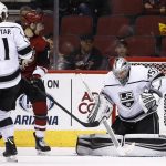 Los Angeles Kings goalie Darcy Kuemper, right, gives up a goal to Arizona Coyotes' Oliver Ekman-Larsson (not shown) as Coyotes' Brendan Perlini, second from left, and Kings center Anze Kopitar (11) look on during the first period of an NHL hockey game Friday, Nov. 24, 2017, in Glendale, Ariz. (AP Photo/Ross D. Franklin)