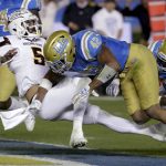 Arizona State quarterback Manny Wilkins, left, scores past UCLA linebacker Kenny Young during the first half of an NCAA college football game in Pasadena, Calif., Saturday, Nov. 11, 2017. (AP Photo/Chris Carlson)