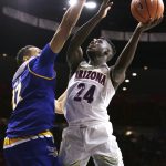 Arizona guard Emmanuel Akot (24) looks for a shot against Cal State Bakersfield center Moataz Aly during the second half of an NCAA college basketball game, Thursday, Nov. 16, 2017, in Tucson, Ariz. Arizona won 91-59. (AP Photo/Rick Scuteri)