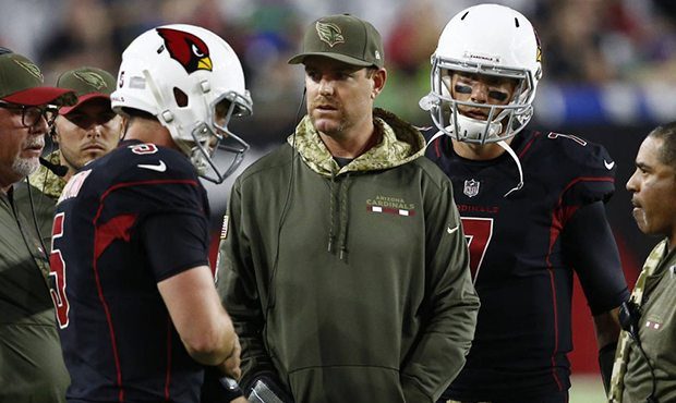 Injured Arizona Cardinals quarterback Carson Palmer, center, talks with quarterback Drew Stanton, l...