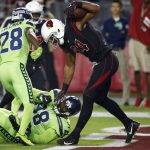 Arizona Cardinals tight end Jermaine Gresham (84) spins around after scoring a touchdown as Seattle Seahawks defensive tackle Garrison Smith (98) and cornerback Justin Coleman (28) defend during the first half of an NFL football game, Thursday, Nov. 9, 2017, in Glendale, Ariz. (AP Photo/Ross D. Franklin)