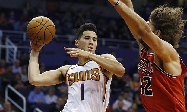 Phoenix Suns guard Devin Booker (1) looks to pass the ball as Chicago Bulls center Robin Lopez (42)...
