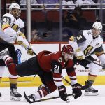 Arizona Coyotes center Derek Stepan (21) gets tripped up by Vegas Golden Knights left wing Pierre-Edouard Bellemare (41) as Golden Knights defenseman Brayden McNabb (3) looks on during the second period of an NHL hockey game Saturday, Nov. 25, 2017, in Glendale, Ariz. (AP Photo/Ross D. Franklin)
