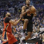 Phoenix Suns forward TJ Warren (12) drives past New Orleans Pelicans forward Anthony Davis in the second half during an NBA basketball game, Friday, Nov 24, 2017, in Phoenix. (AP Photo/Rick Scuteri)