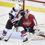 Washington Capitals goalie Braden Holtby, right, stops the puck against Arizona Coyotes center Derek Stepan (21) during the third period of an NHL hockey game, Monday, Nov. 6, 2017, in Washington. The Capitals won 3-2 in overtime. (AP Photo/Nick Wass)