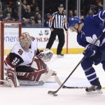 Arizona Coyotes goalie Antti Raanta, left,  makes a save against Toronto Maple Leafs center Zach Hyman, right, during first period NHL hockey action in Toronto on Monday, Nov. 20, 2017. (Nathan Denette/The Canadian Press via AP)