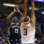 Brooklyn Nets guard Caris LeVert (22) loses control of the ball in front of Phoenix Suns forward Jared Dudley (3) during the first half of an NBA basketball game Monday, Nov. 6, 2017, in Phoenix. (AP Photo/Ross D. Franklin)