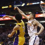 Phoenix Suns center Alex Len (21) and Los Angeles Lakers guard Lonzo Ball (2) tip the ball during the second half of an NBA basketball game Monday, Nov. 13, 2017, in Phoenix. The Lakers won 100-93. (AP Photo/Ross D. Franklin)