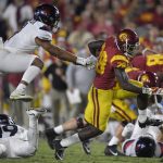 Southern California running back Aca'Cedric Ware, right, runs the ball as Arizona linebacker Tony Fields II, top left, gives chase during the first half of an NCAA college football game, Saturday, Nov. 4, 2017, in Los Angeles. (AP Photo/Mark J. Terrill)