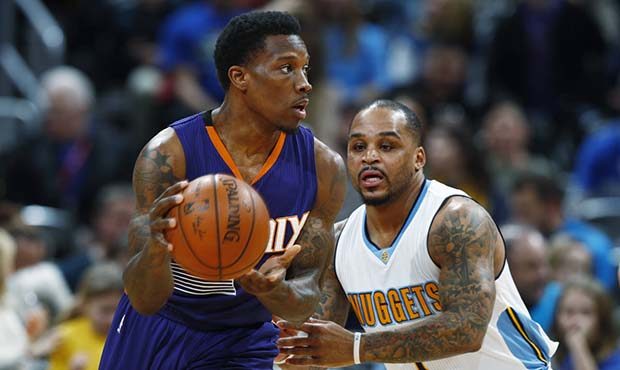 Phoenix Suns guard Eric Bledsoe, left, looks to pass the ball as Denver Nuggets guard Jameer Nelson...