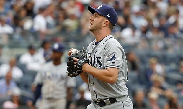 Tampa Bay Rays relief pitcher Brad Boxberger reacts after hitting New York Yankees' Todd Frazier wi...